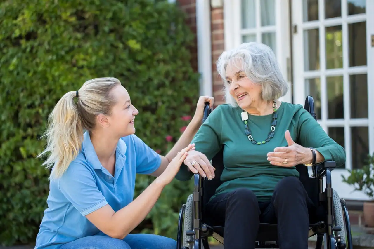 Caregiver assisting an elderly resident at Parkmount Manor